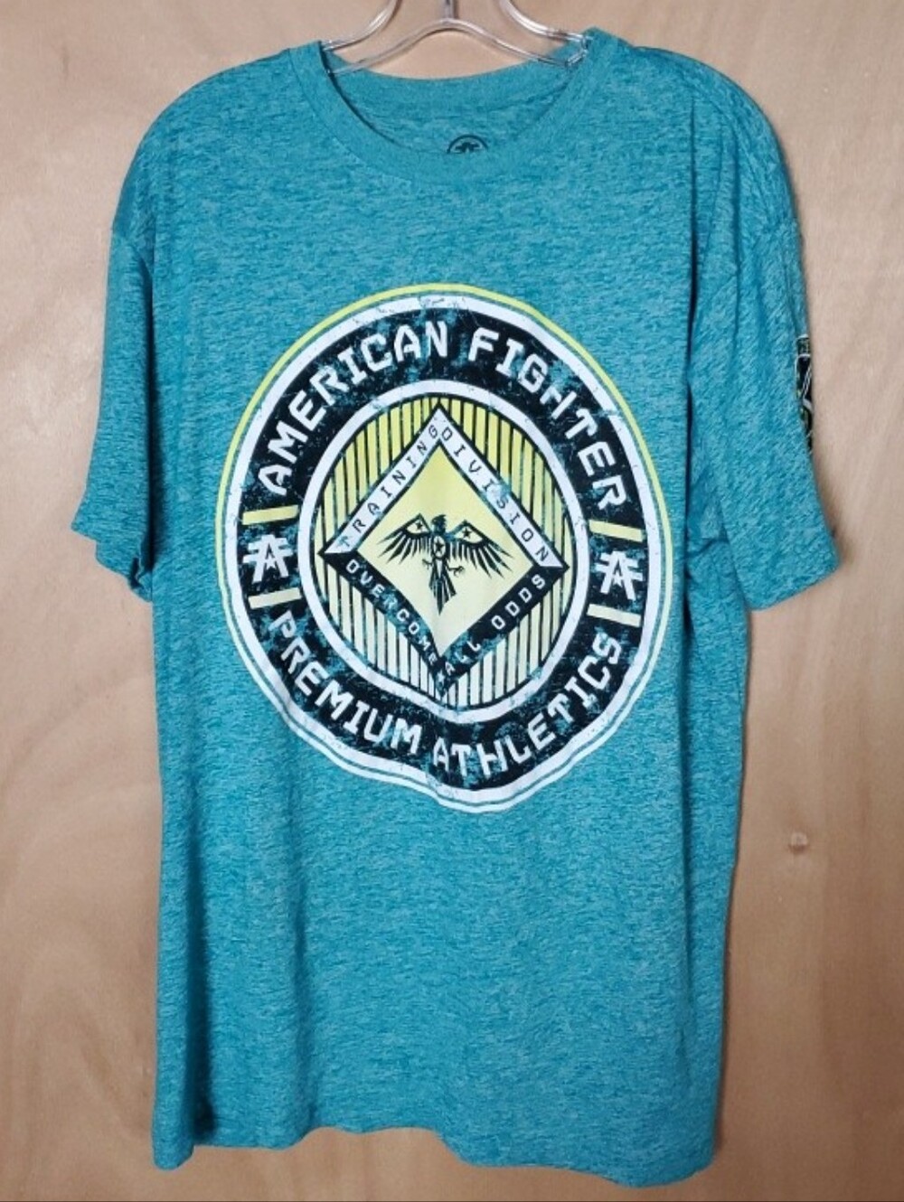 American Fighter Teal Short Sleeve Graphic Tee with Yellow & Black Crest
